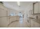 Functional kitchen with white cabinetry, neutral countertops, and an open view of the dining area at 163 Chrysanthemum Dr, Ormond Beach, FL 32174