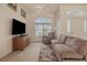 Cozy living room featuring a large window, comfortable sofa, and a neutral color palette at 163 Chrysanthemum Dr, Ormond Beach, FL 32174