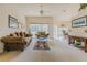 Bright living room with large windows, neutral carpet, and comfortable seating arrangement at 163 Chrysanthemum Dr, Ormond Beach, FL 32174