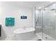 Modern bathroom with a soaking tub and a walk-in shower at 164 E Fiesta Key Loop, Deland, FL 32720