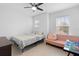 Cozy bedroom with a bed, sofa, and window coverings at 164 E Fiesta Key Loop, Deland, FL 32720