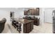 Island kitchen with granite countertops and dark wood cabinets at 164 E Fiesta Key Loop, Deland, FL 32720