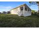 Side view of the home showing the outdoor porch with lake views at 177 Rosedale Dr, Deltona, FL 32738