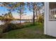 Lush backyard with a lake view from the home's exterior at 177 Rosedale Dr, Deltona, FL 32738