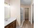 Modern bathroom vanity with dual sinks and glass-enclosed shower at 177 Rosedale Dr, Deltona, FL 32738