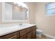 Bathroom featuring a dual vanity with modern finishes, a window, and a toilet at 177 Rosedale Dr, Deltona, FL 32738