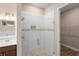 Modern glass shower featuring designer tile, seamlessly blending with a spacious vanity at 177 Rosedale Dr, Deltona, FL 32738