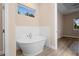 Freestanding tub with window, blending relaxation and natural light at 177 Rosedale Dr, Deltona, FL 32738