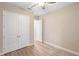 Bright bedroom with neutral walls, a ceiling fan, and double closet doors at 177 Rosedale Dr, Deltona, FL 32738