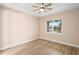 Light-filled bedroom featuring wood flooring and a ceiling fan at 177 Rosedale Dr, Deltona, FL 32738