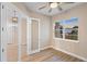 Bedroom with a ceiling fan and wood-look flooring, plus a view of the exterior through a window at 177 Rosedale Dr, Deltona, FL 32738