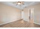 Bright bedroom features light wood floors and modern ceiling fan at 177 Rosedale Dr, Deltona, FL 32738