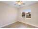 Bedroom featuring a ceiling fan and wood-look flooring with a view of the exterior at 177 Rosedale Dr, Deltona, FL 32738