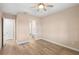 Bedroom featuring wood flooring, a ceiling fan and access to a bathroom at 177 Rosedale Dr, Deltona, FL 32738
