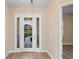 Bright entryway with a glass paneled front door and wood-look floors at 177 Rosedale Dr, Deltona, FL 32738