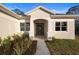Beautifully landscaped front entrance featuring an arched entryway and decorative plants at 177 Rosedale Dr, Deltona, FL 32738