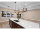 Island kitchen featuring pendant lights, stainless appliances, and stunning water views at 177 Rosedale Dr, Deltona, FL 32738