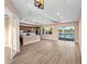 Open-concept living room featuring wood floors, modern lighting, and access to the lake at 177 Rosedale Dr, Deltona, FL 32738