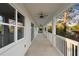 Long porch with multiple fans and a railing with lake view at 177 Rosedale Dr, Deltona, FL 32738