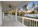 Long porch with multiple fans and a railing overlooking the lake at 177 Rosedale Dr, Deltona, FL 32738