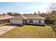 Well-maintained single-story home with an attached garage and a sunny front lawn at 1794 Morven Ct, Deltona, FL 32738