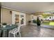 Outdoor patio with white chairs, plants, and tile flooring offers a cozy space for relaxation and entertaining at 1944 Poinsettia Dr, Port Orange, FL 32128