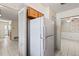 White refrigerator in kitchen with wood cabinets at 2001 Mike St, South Daytona, FL 32119