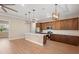 Modern kitchen featuring an island, stainless steel appliances, and light-colored laminate flooring at 2060 Watersedge Dr, Deltona, FL 32738