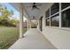 Relaxing covered patio with ceiling fans and plenty of space for outdoor seating at 2060 Watersedge Dr, Deltona, FL 32738