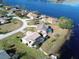 Aerial view of waterfront homes with mature trees, screened in pools, and grass lawns at 2075 Little Farms Ct, Deltona, FL 32738