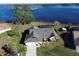 Stunning aerial view showcasing the property's proximity to the lake and its screened-in pool at 2075 Little Farms Ct, Deltona, FL 32738