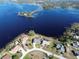 Aerial view of waterfront homes with mature trees, screened in pools, and grass lawns at 2075 Little Farms Ct, Deltona, FL 32738