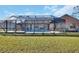 Backyard featuring a screened-in pool and lush green lawn provides an ideal setting for outdoor relaxation and recreation at 2075 Little Farms Ct, Deltona, FL 32738