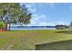 Lush green backyard with lake views offers a tranquil outdoor space for relaxation and recreation at 2075 Little Farms Ct, Deltona, FL 32738