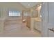 Bathroom featuring a bathtub, shower, and a block glass window at 2075 Little Farms Ct, Deltona, FL 32738