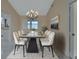 Elegant dining room featuring modern chandelier, large windows, and seating for eight at 2075 Little Farms Ct, Deltona, FL 32738