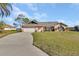 Lovely brick home featuring a spacious front yard, two-car garage, and picturesque landscaping at 2075 Little Farms Ct, Deltona, FL 32738