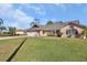 Charming one-story brick home featuring a well-manicured lawn, two car garage, and inviting front entrance at 2075 Little Farms Ct, Deltona, FL 32738