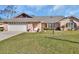 Charming single-story home with a brick facade, well-maintained lawn, and a two-car garage at 2075 Little Farms Ct, Deltona, FL 32738