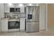 Modern kitchen with stainless steel appliances, white cabinets, and plenty of storage space for cooking needs at 2075 Little Farms Ct, Deltona, FL 32738