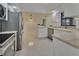 Spacious kitchen featuring stainless steel appliances, white cabinets, and an island with a sink at 2075 Little Farms Ct, Deltona, FL 32738