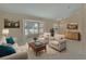 Bright living room with large windows, neutral tones, and stylish furnishings at 2075 Little Farms Ct, Deltona, FL 32738