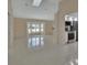 Open living room with ample natural light, tile flooring, and kitchen access, great for entertaining at 2075 Little Farms Ct, Deltona, FL 32738