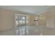 Sun-filled living room featuring tile floors, large windows with shutters, and neutral paint at 2075 Little Farms Ct, Deltona, FL 32738