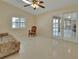 Bright living room with tile flooring, ceiling fan, and access to the outdoor pool area at 2075 Little Farms Ct, Deltona, FL 32738