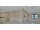 Open living space with vaulted ceilings, tile flooring, and view of the lake at 2075 Little Farms Ct, Deltona, FL 32738