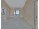 Bright, airy living room with tiled flooring, large window, and neutral walls offers a serene space at 2075 Little Farms Ct, Deltona, FL 32738