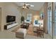 Inviting living room features comfortable seating, a skylight, and seamless access to the outdoor pool area at 2075 Little Farms Ct, Deltona, FL 32738