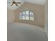 Bright main bedroom with large arched windows, vaulted ceiling, and plush carpet at 2075 Little Farms Ct, Deltona, FL 32738