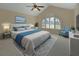 Cozy main bedroom features a large window, vaulted ceiling, and calming decor at 2075 Little Farms Ct, Deltona, FL 32738